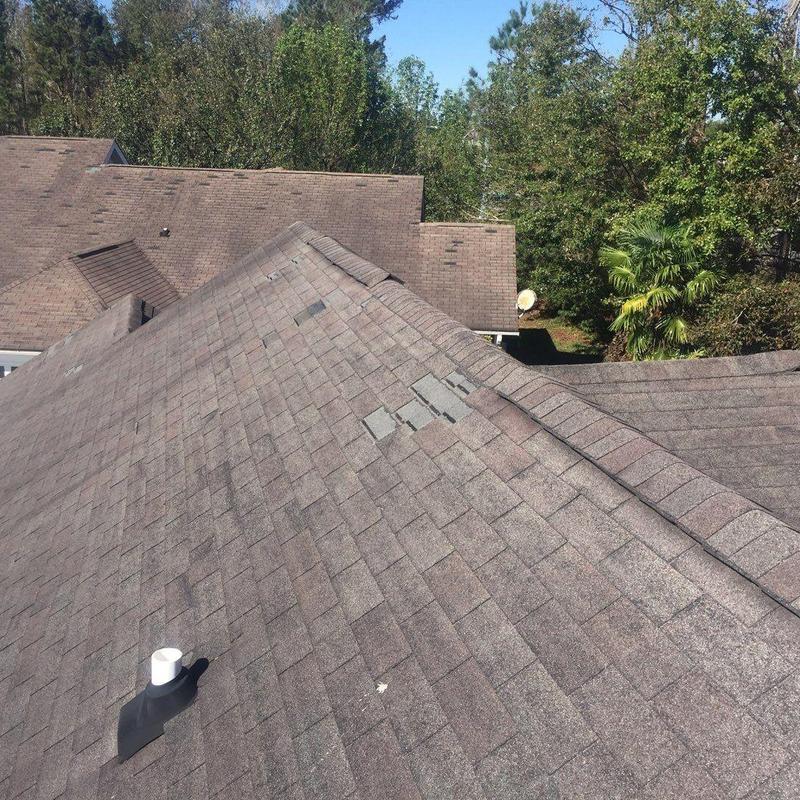 Asphalt roof shingles with hail damage and repairs