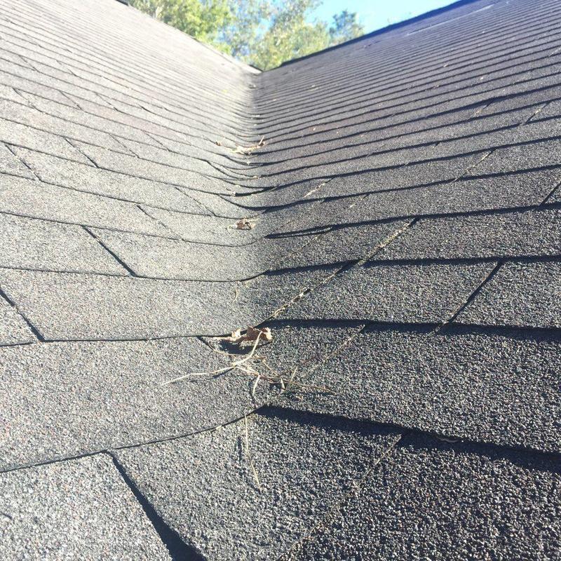 Roof shingles and valley with minor debris on slope