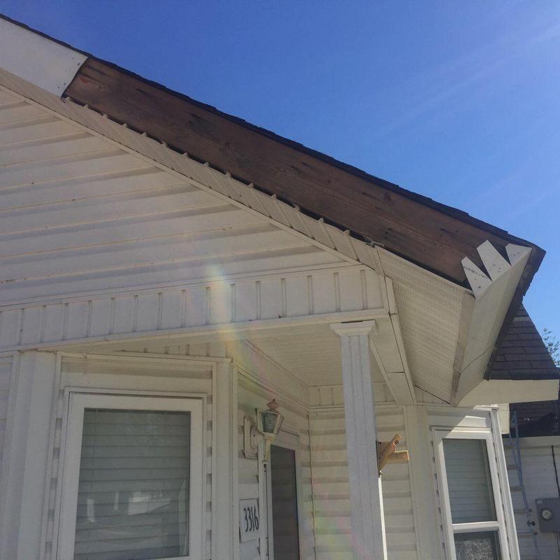 Roof edge sheathing and fascia inspection under blue sky