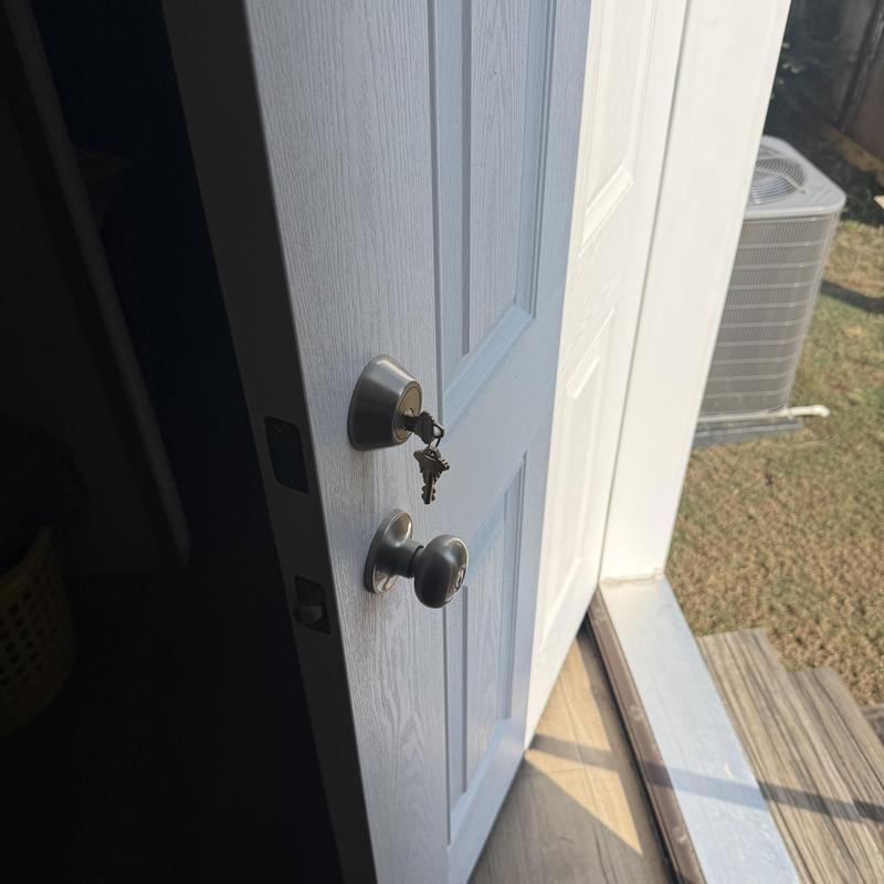 Mobile home door lock with keys hanging in Tulsa