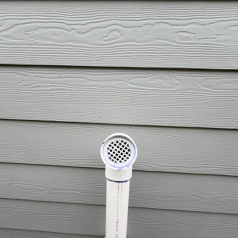 Heater exhaust vent pipe installed on house siding