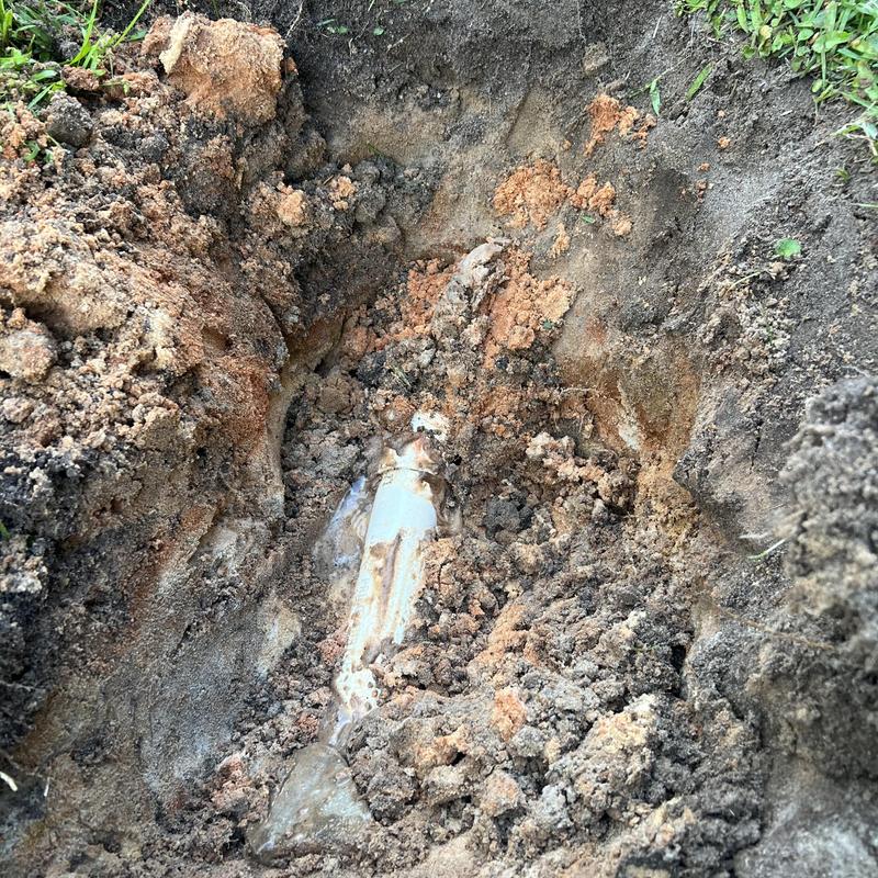 Water service line leak exposed in soil trench Water service line leak exposed in soil trench