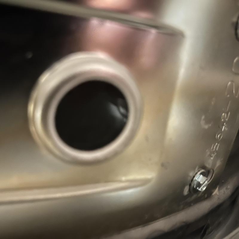 Power vent water heater metal tank opening close-up