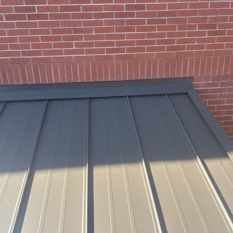 Metal roof flashing installation on brick wall Metal roof flashing installation on brick wall