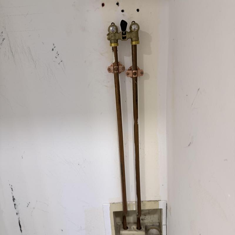 Laundry valve with copper supply pipes installed on wall Laundry valve with copper supply pipes installed on wall