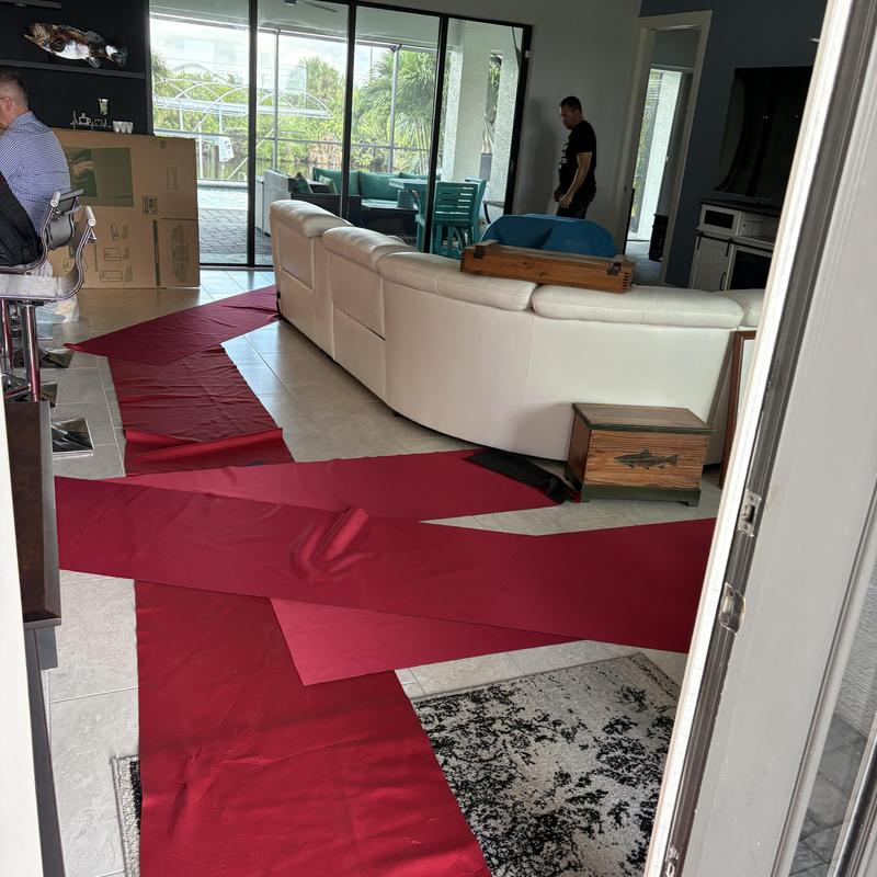 Floor protection with red covers during move in living room