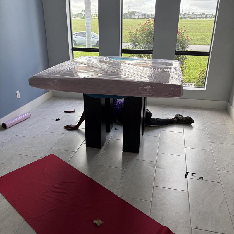 Marble dining table wrapped for moving in room