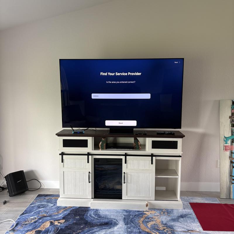 8K TV setup on white entertainment console