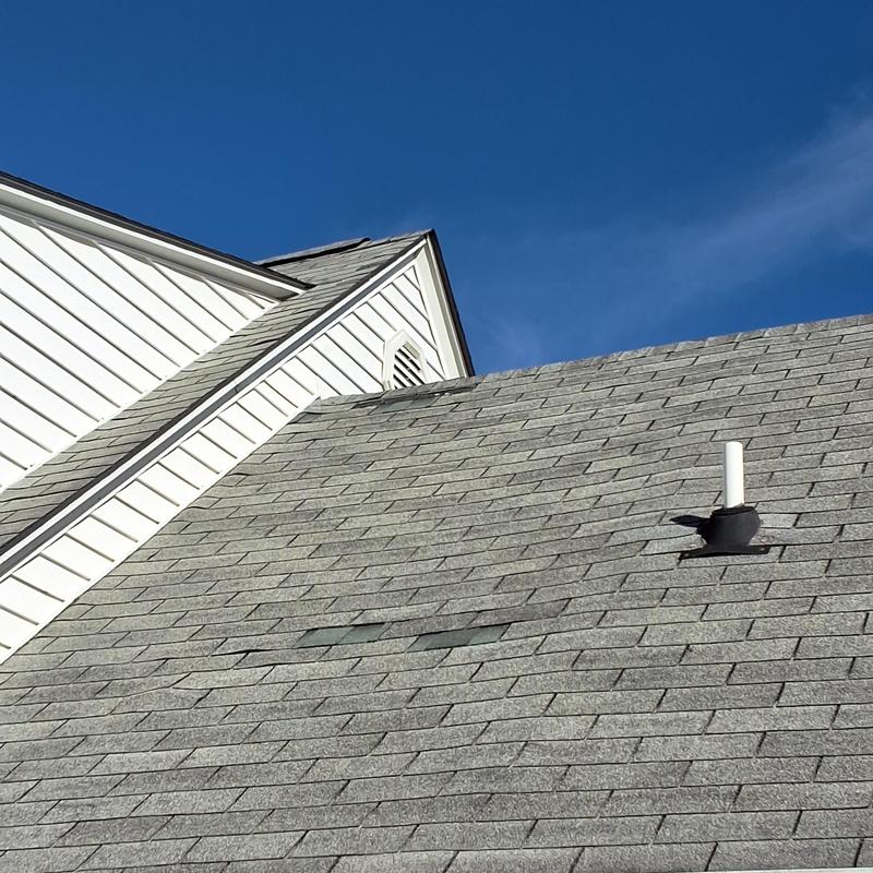 Asphalt shingle roof with damaged areas and vent pipe Asphalt shingle roof with damaged areas and vent pipe