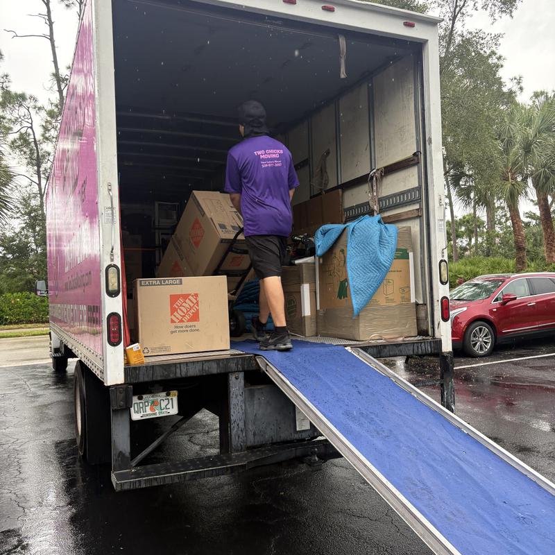 Moving boxes and household items loading into truck ramp