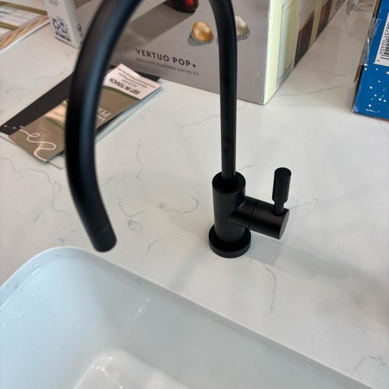Black drinking faucet installation on kitchen countertop