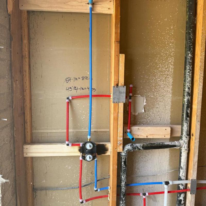 Shower rough-in valve with red and blue PEX piping