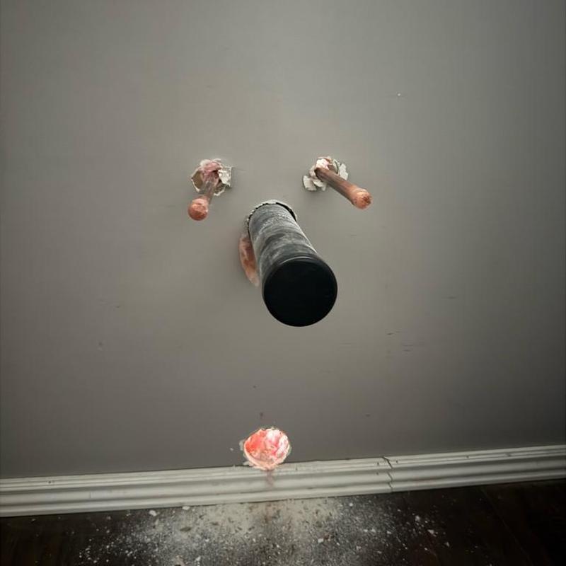 Laundry room plumbing pipes protruding from wall installation