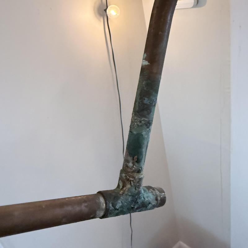 Copper plumbing pipe with corrosion and pinhole leak damage Copper plumbing pipe with corrosion and pinhole leak damage
