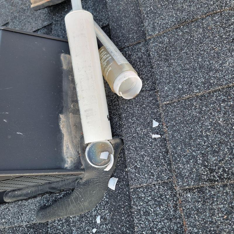 PVC vent pipe with cracked cap on shingle roof