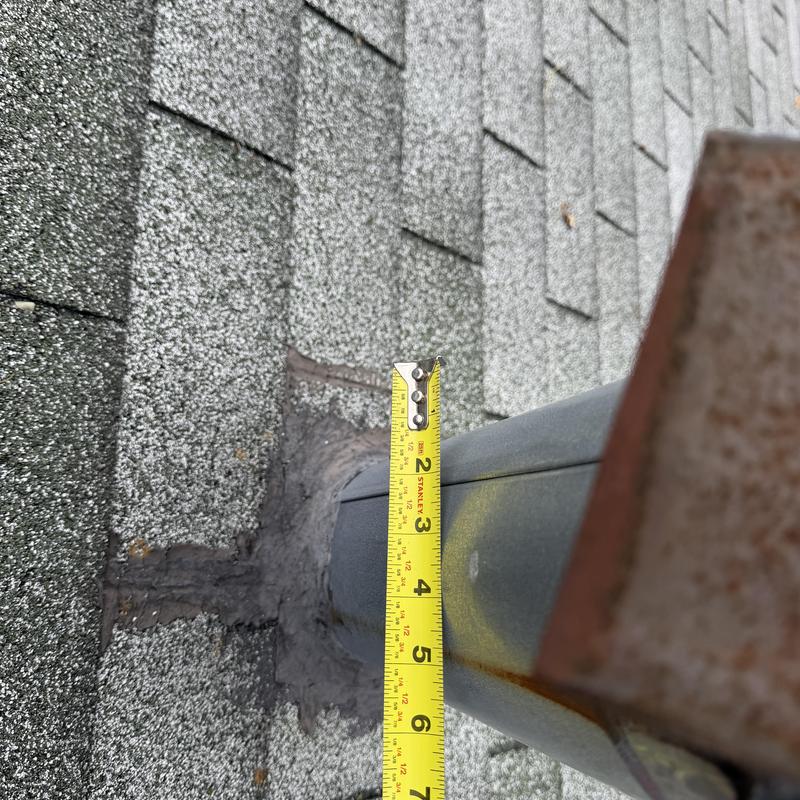 Gas vent with patch and measuring tape on roof Gas vent with patch and measuring tape on roof