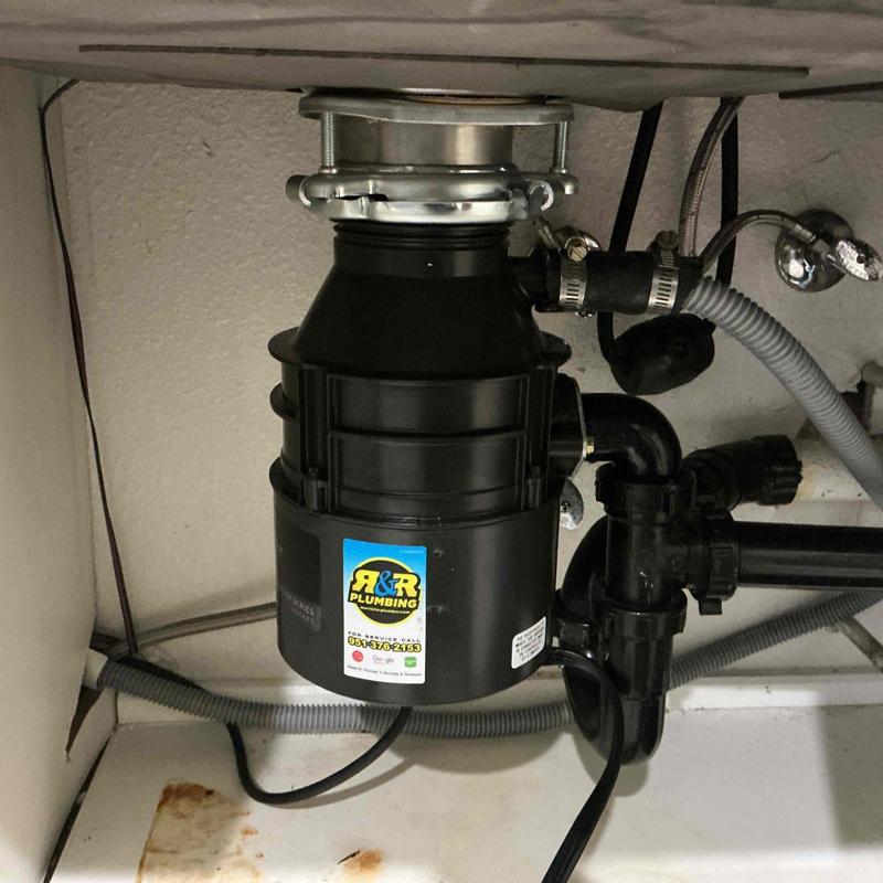 Garbage disposal unit installed under kitchen sink