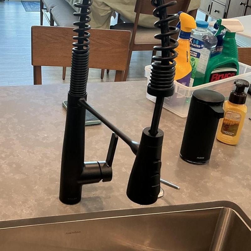 Black kitchen faucet with spring spout installed
