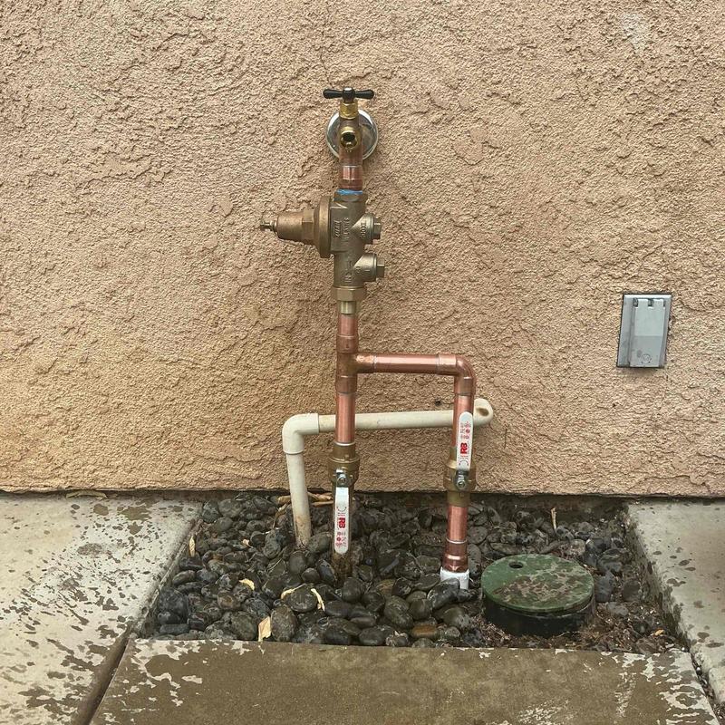 Pressure reducing valve and water main riser assembly outdoors