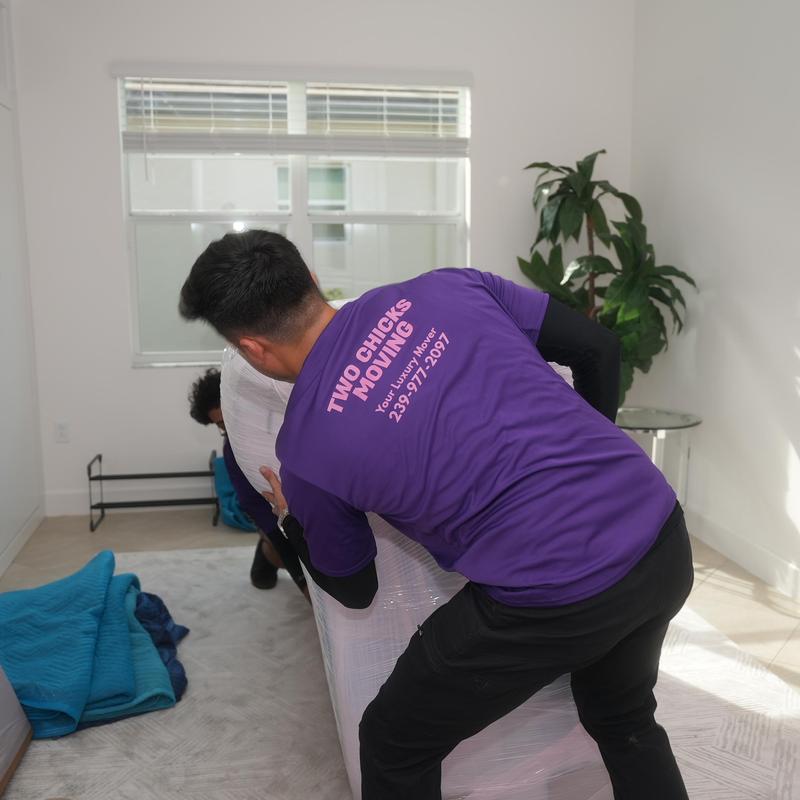 Furniture moving with protective wrapping in residential room