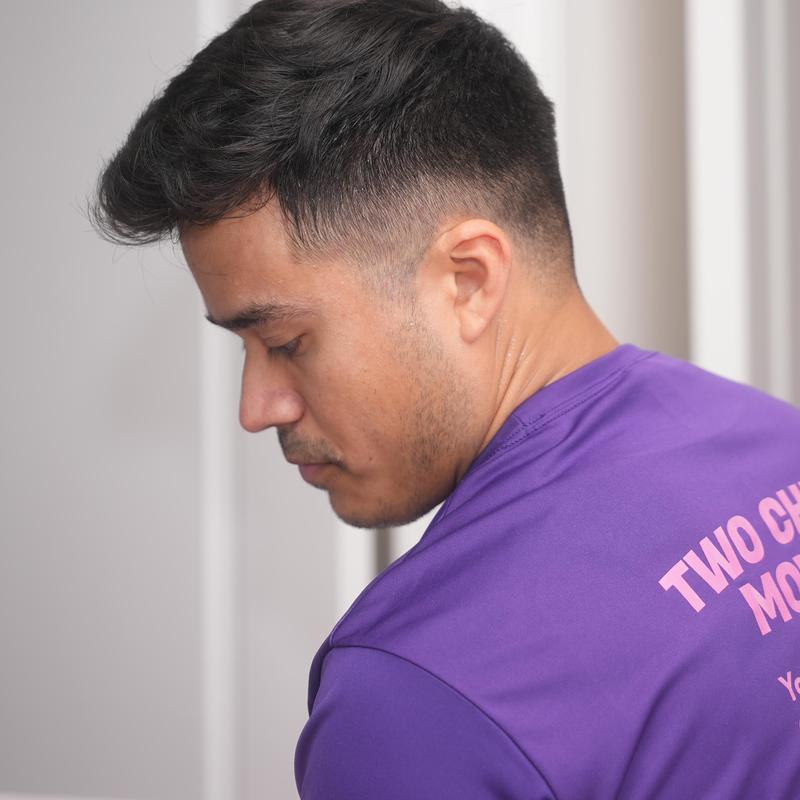 Moving service worker in purple shirt handling move