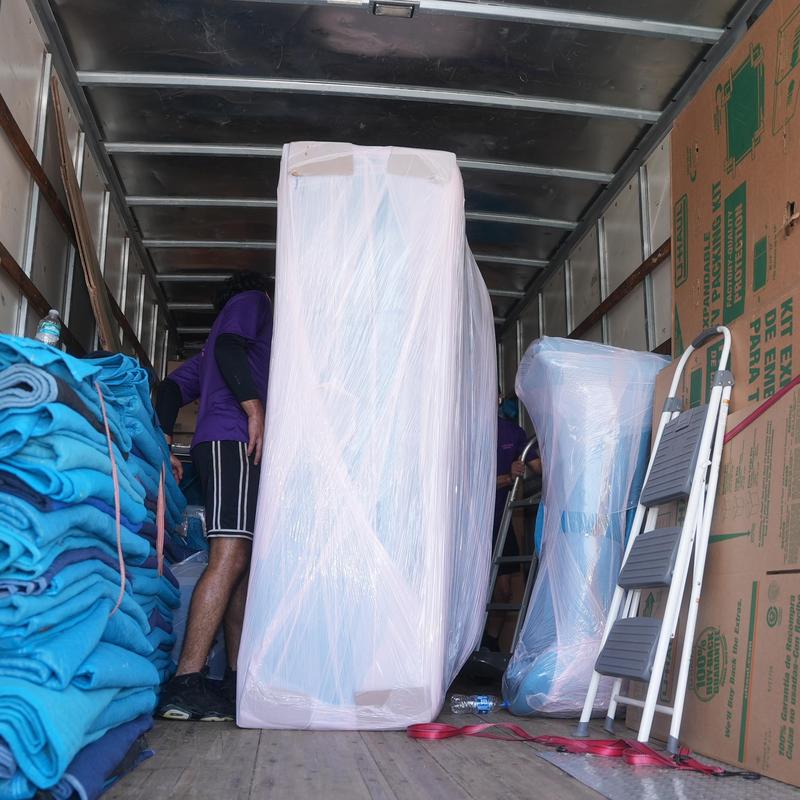 Wrapped furniture in moving truck with protective blankets