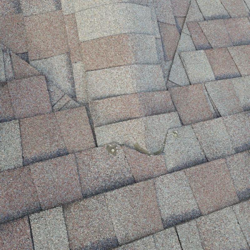 Asphalt shingle roof with hail damage and wear