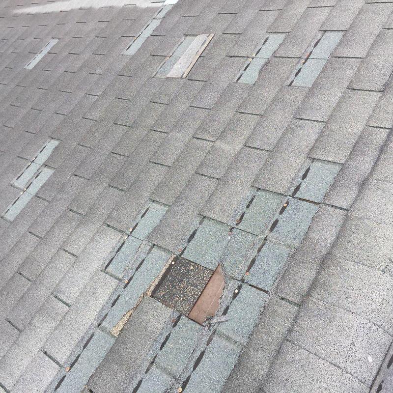 Asphalt shingle roof with hail damage and missing granules