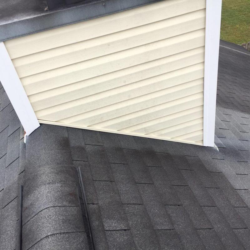 Roof shingles and siding near chimney base