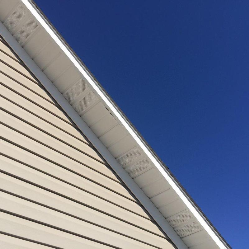 Roof soffit and siding under clear blue sky