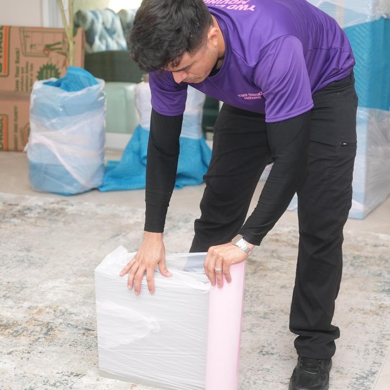 Furniture wrapped with protective plastic wrap during move
