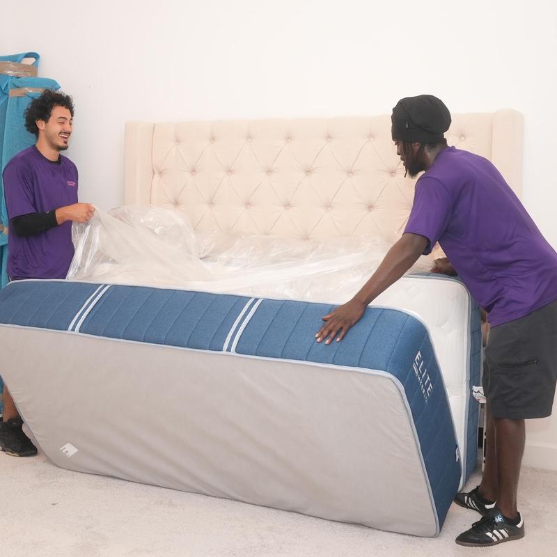 Mattress wrapping and moving by two workers