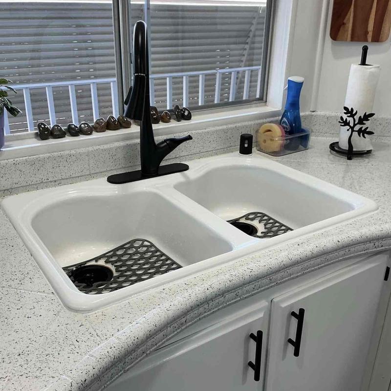 Cast iron kitchen sink with black faucet installed