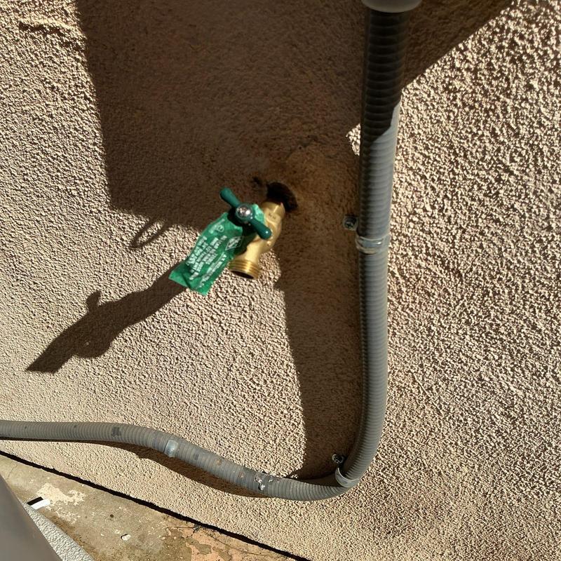 Brass hose bib installed on exterior wall