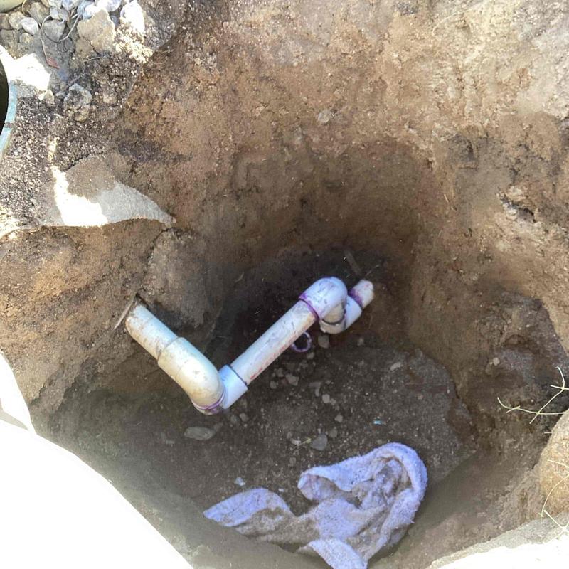 1-inch PVC pipe with new fittings in ground hole