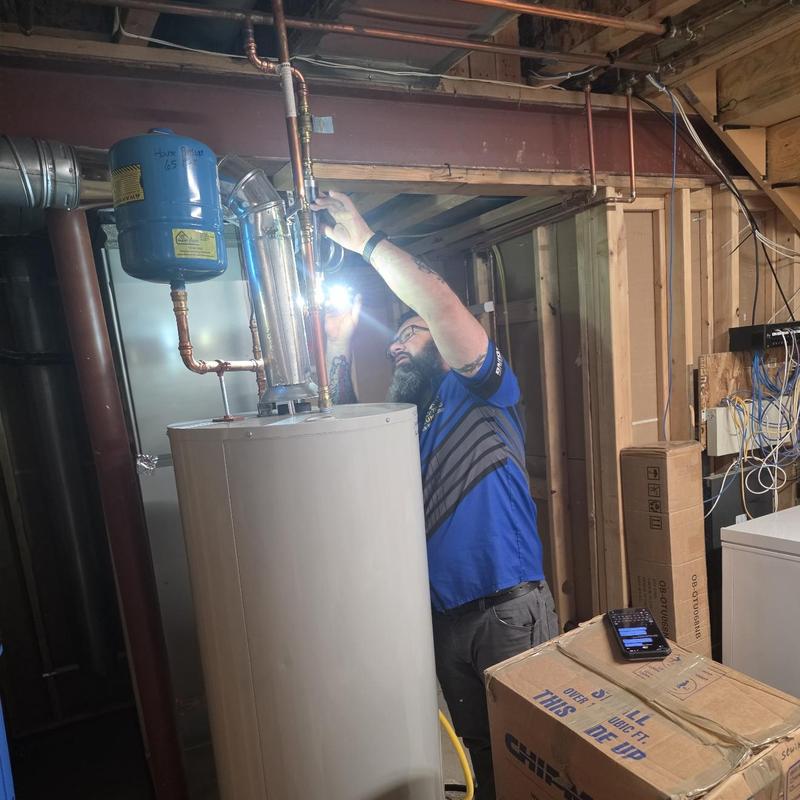 Water heater pipe inspection and flushing in basement