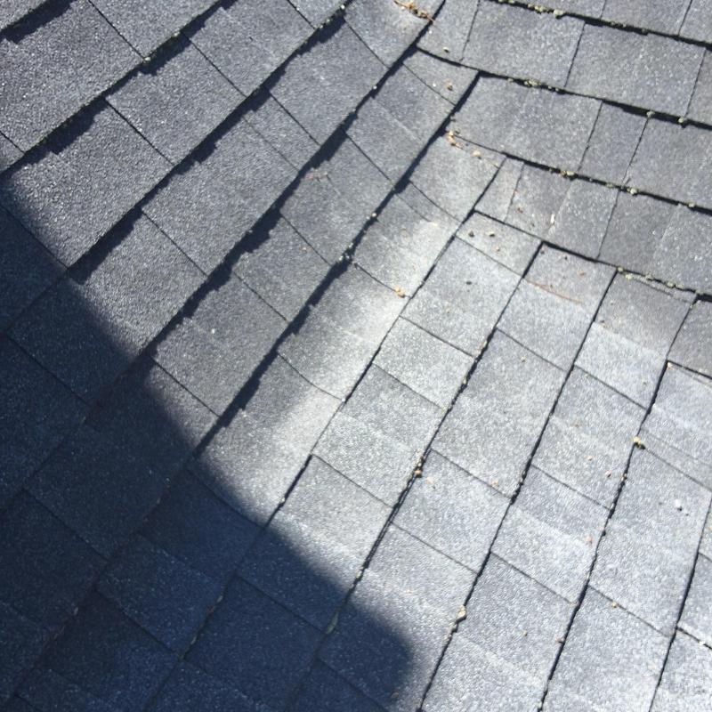 Roof shingles at five-section roof transition with damage Roof shingles at five-section roof transition with damage