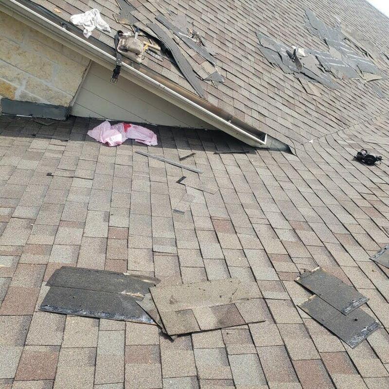 Asphalt shingle roof damage with loose shingles Asphalt shingle roof damage with loose shingles