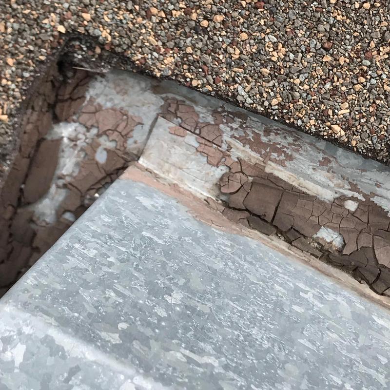 Roof flashing with cracked sealant and aged shingles Roof flashing with cracked sealant and aged shingles