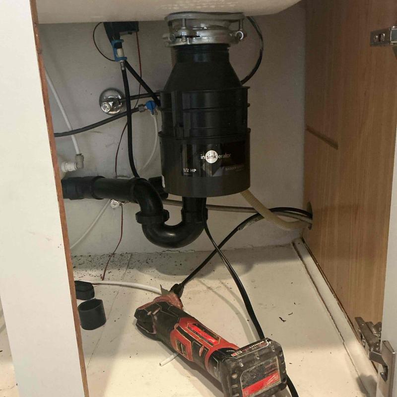 Garbage disposal unit and plumbing connections under sink