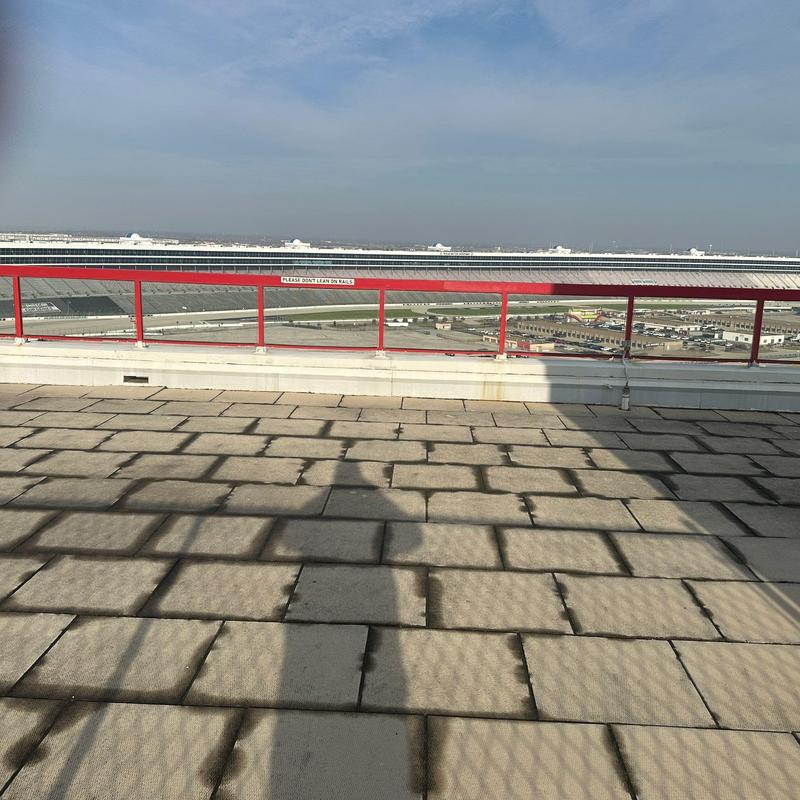 Flat roof membrane inspection with red safety railings Flat roof membrane inspection with red safety railings