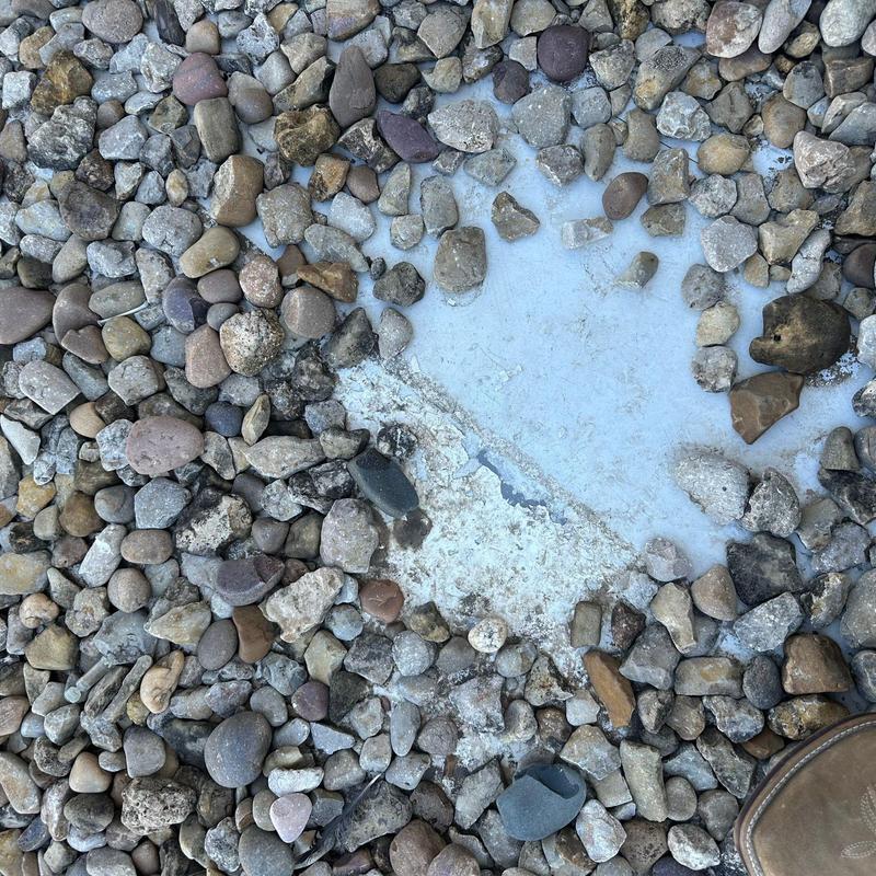 Roof membrane exposed under gravel on commercial roof Roof membrane exposed under gravel on commercial roof