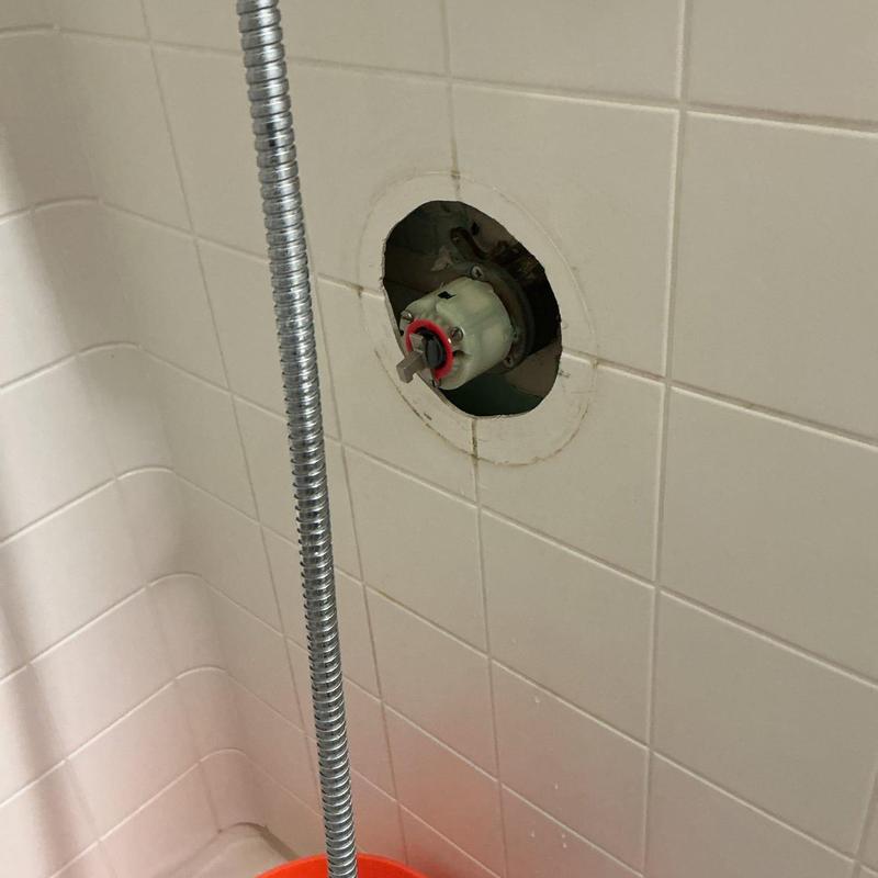 Shower valve cartridge installed in tiled wall opening