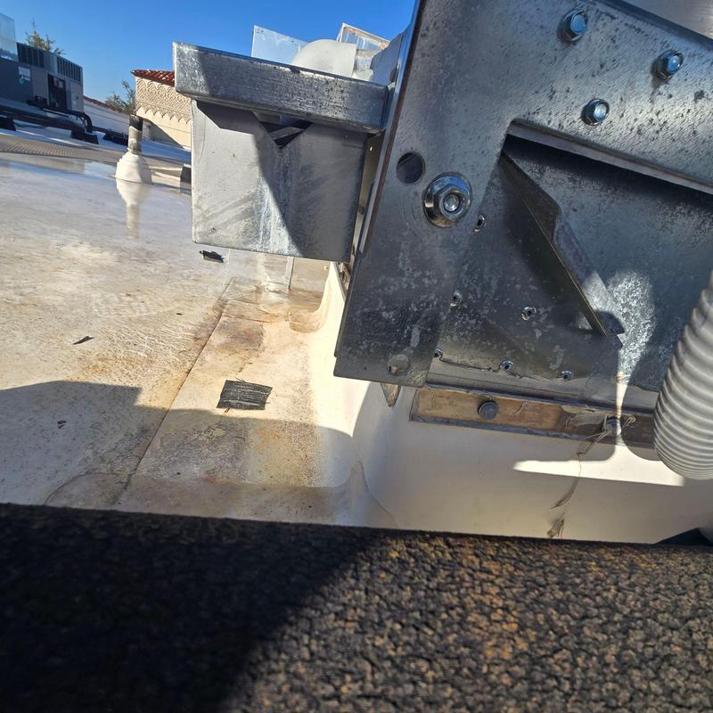 Roof drain and metal flashing on flat roof surface Roof drain and metal flashing on flat roof surface
