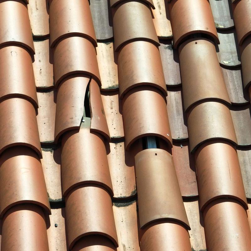 Clay roof tiles with visible cracked tile defect Clay roof tiles with visible cracked tile defect