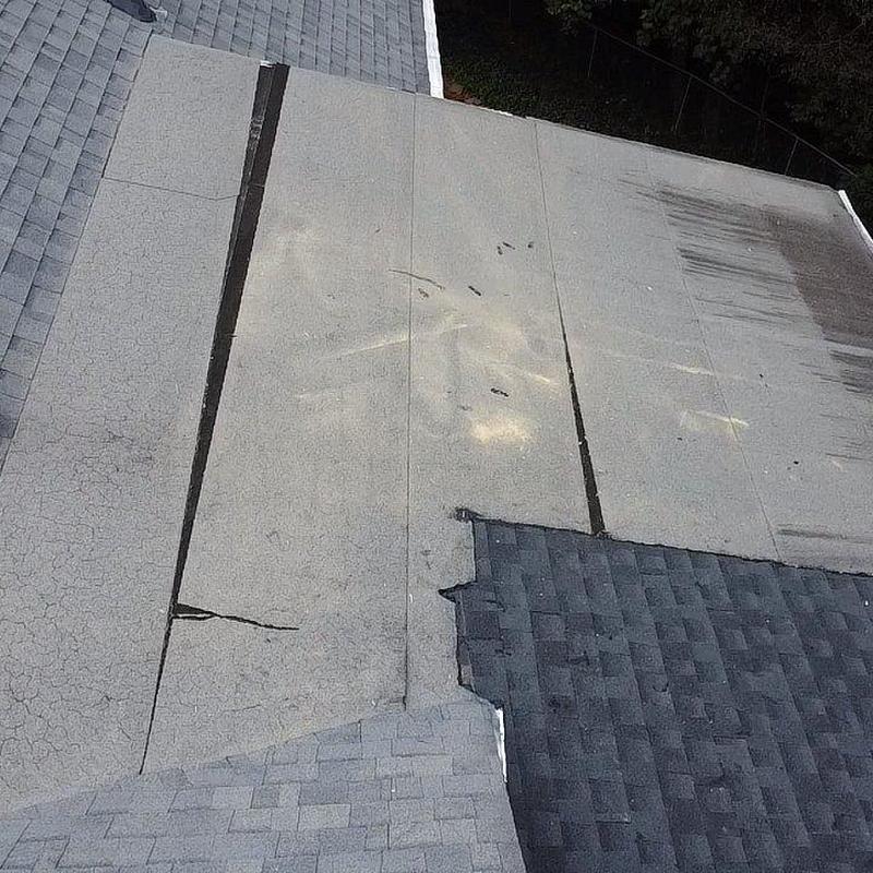 Asphalt shingle roof with damaged underlayment layers Asphalt shingle roof with damaged underlayment layers