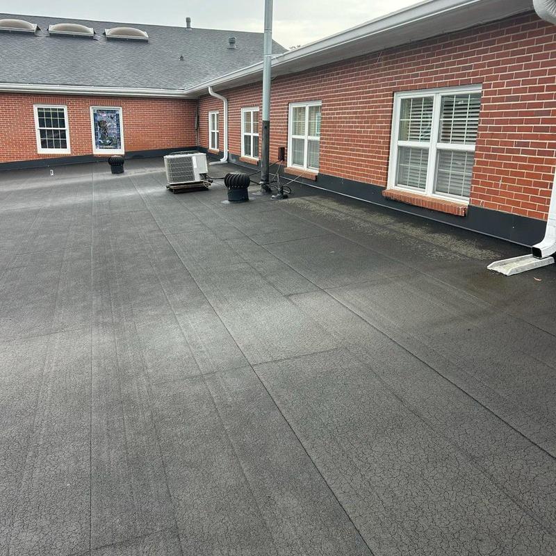Low-slope commercial roof membrane with vents and flashing Low-slope commercial roof membrane with vents and flashing