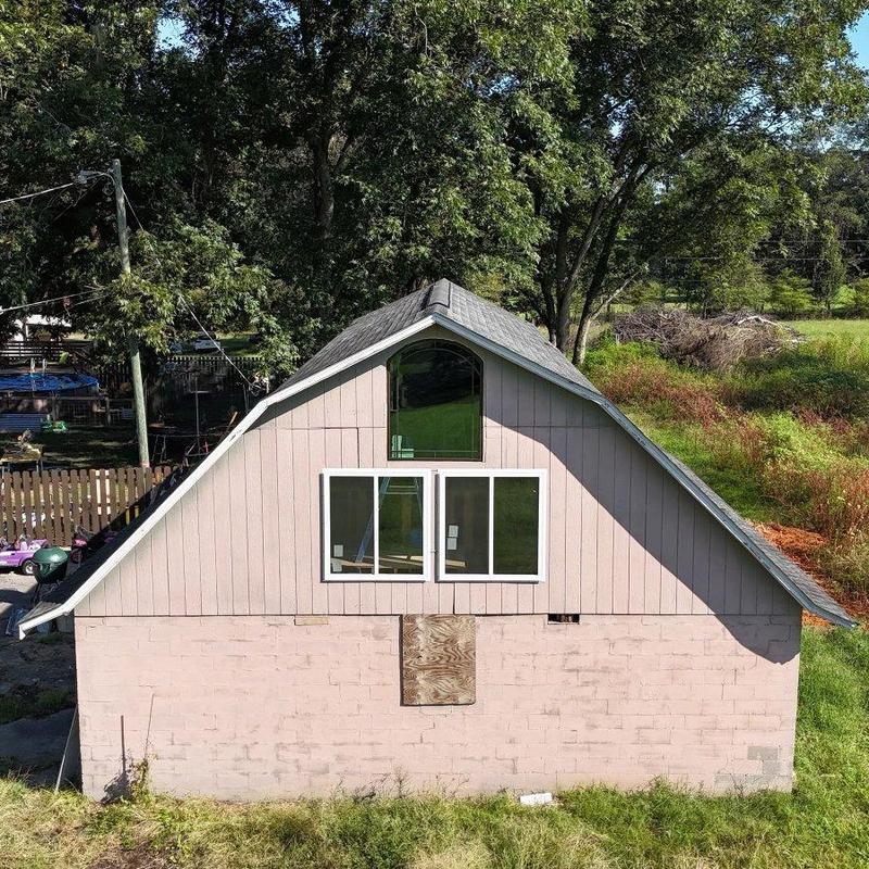 Asphalt shingle roof with upper windows and siding Asphalt shingle roof with upper windows and siding