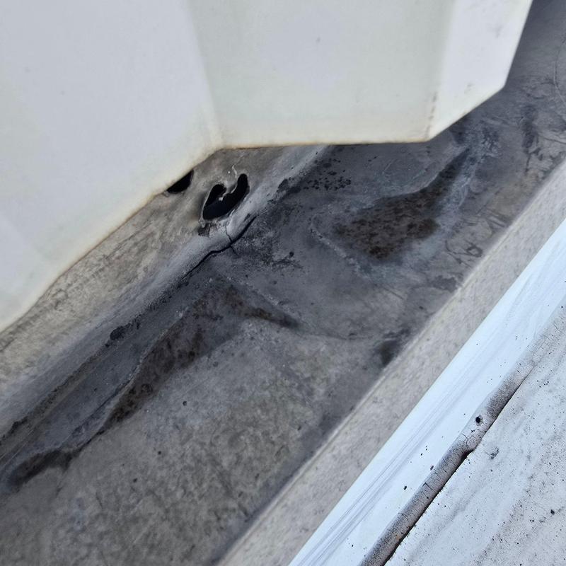 Commercial roof flashing with damaged sealant and cracking Commercial roof flashing with damaged sealant and cracking