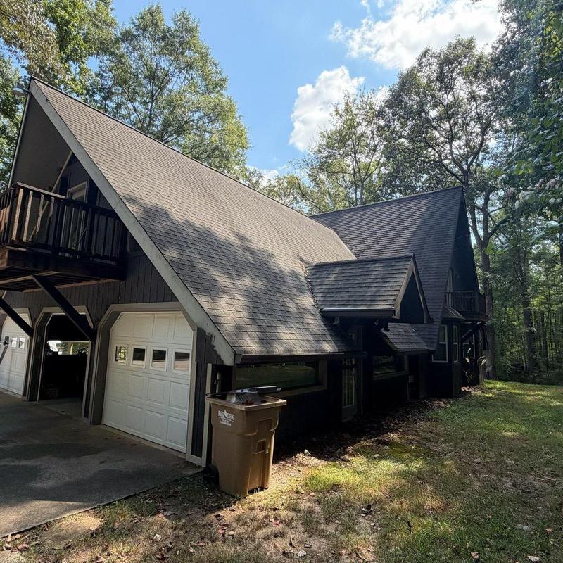 Asphalt shingle roof on residential home with garage Asphalt shingle roof on residential home with garage